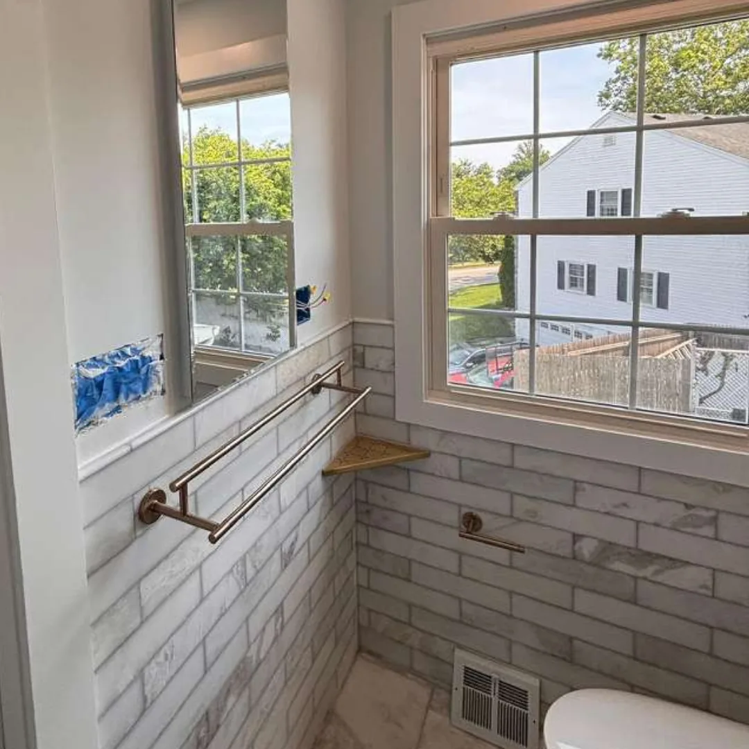 Bathroom with new subway tile, window, and mirror