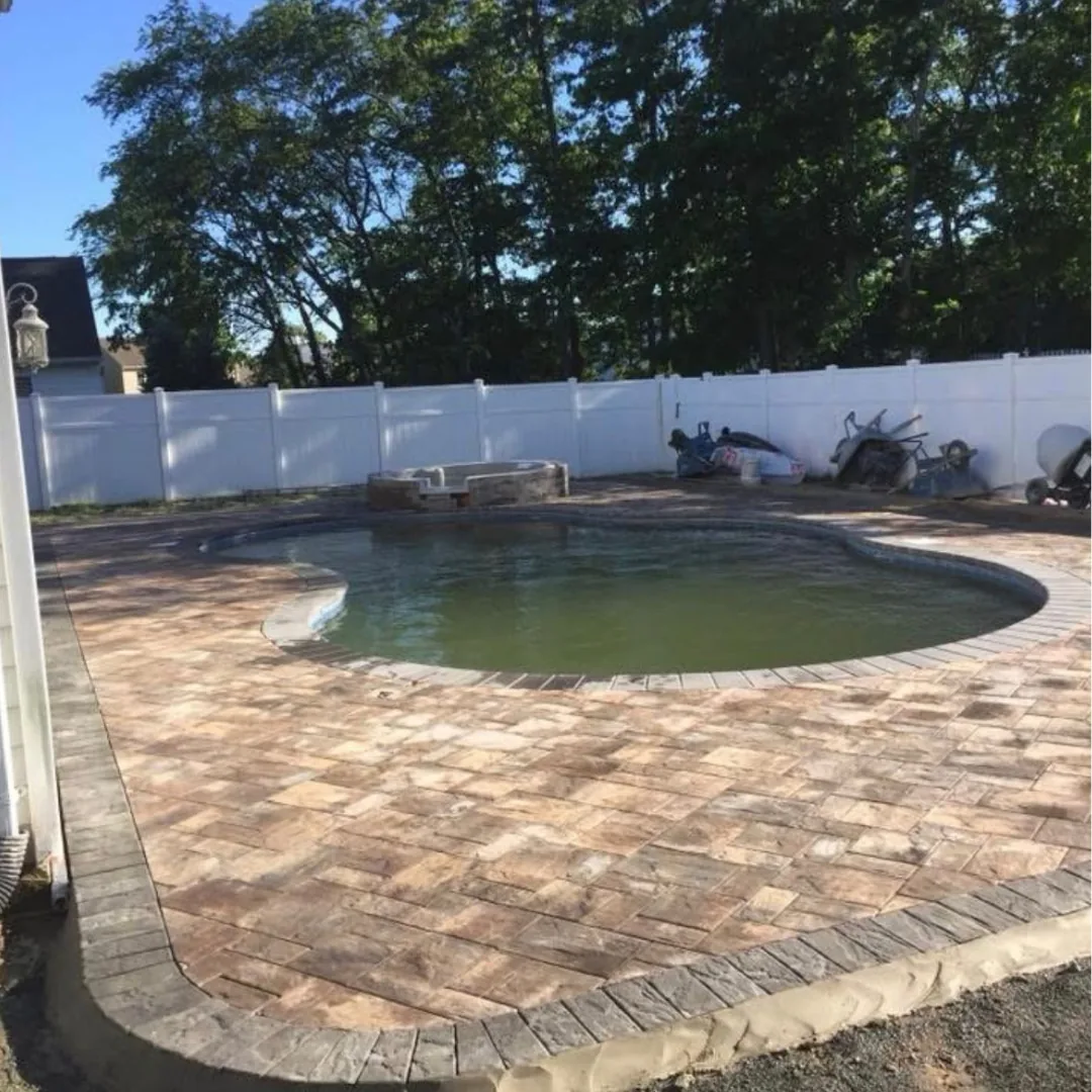 New patio pavers around a swimming pool.