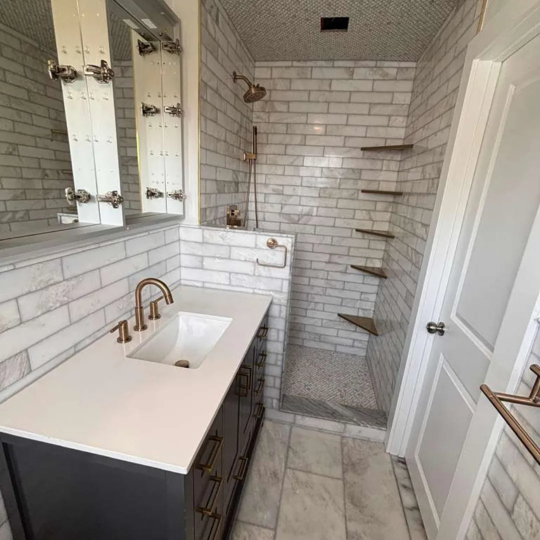 Beautifully tiled bathroom with new vanity and shower.