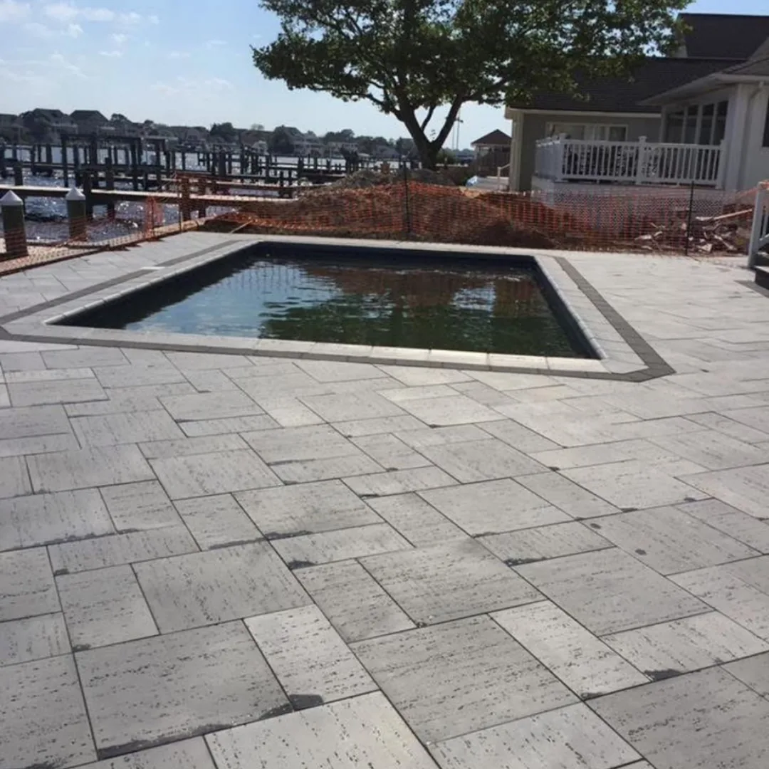 New patio and pool installation by the water.