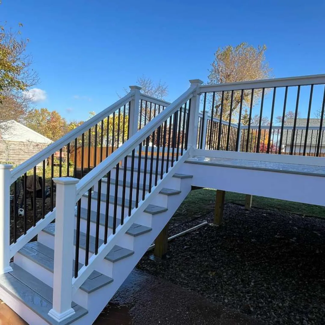 Newly installed deck stairs with white railings.