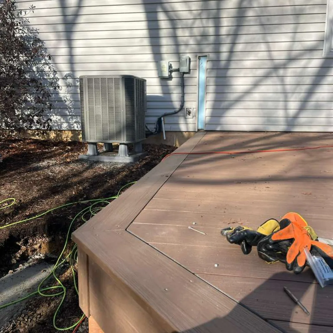 Newly installed brown composite deck with HVAC unit