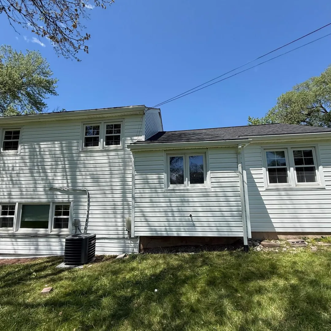 Side of house with new siding and roof.