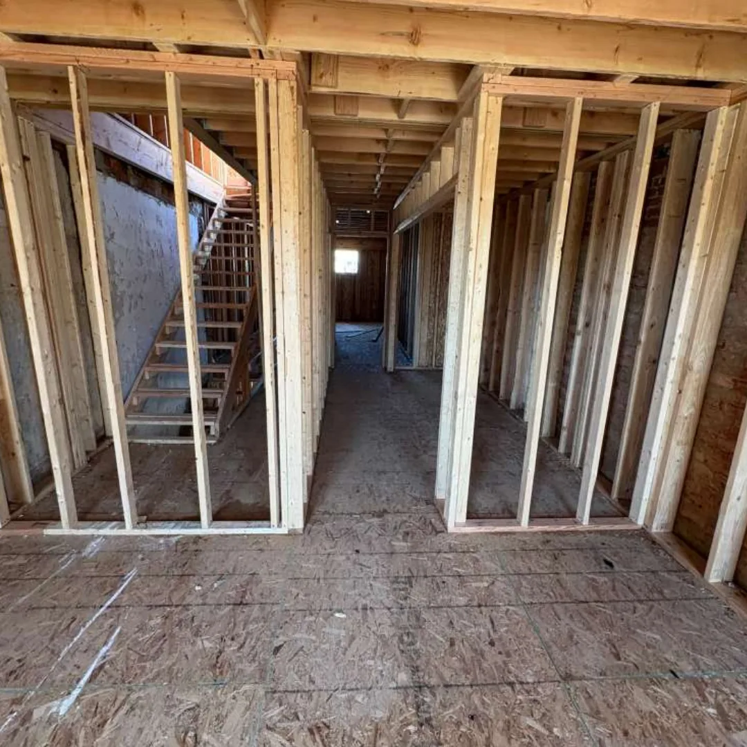 Interior wood framing and subfloor construction.