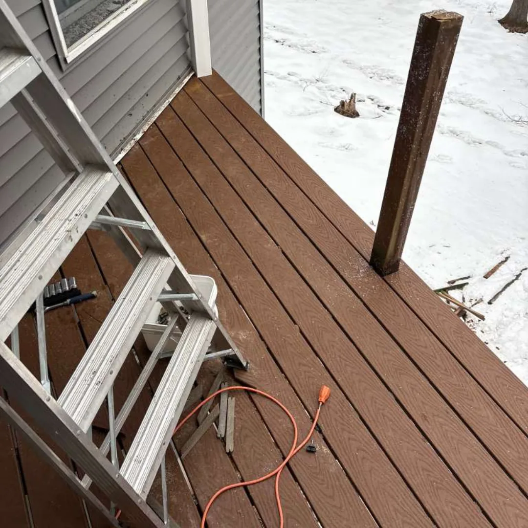 New brown composite deck with ladder and tools.