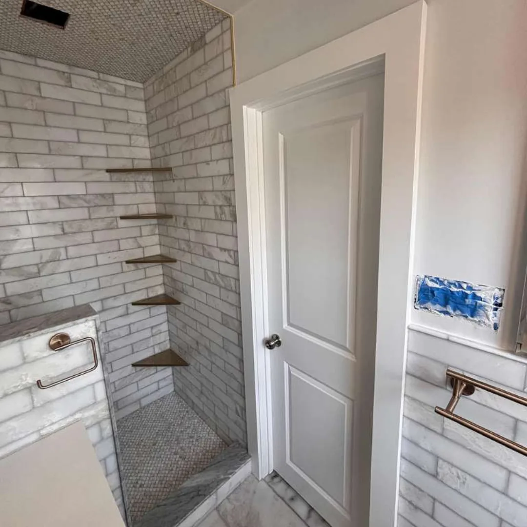 Bathroom with white subway tile shower and new door.